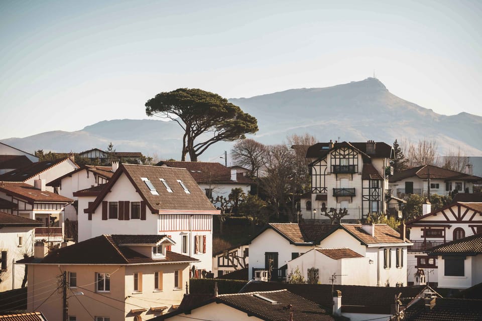 The red-roofed houses and rolling hills paint the timeless charm of the Basque coast.