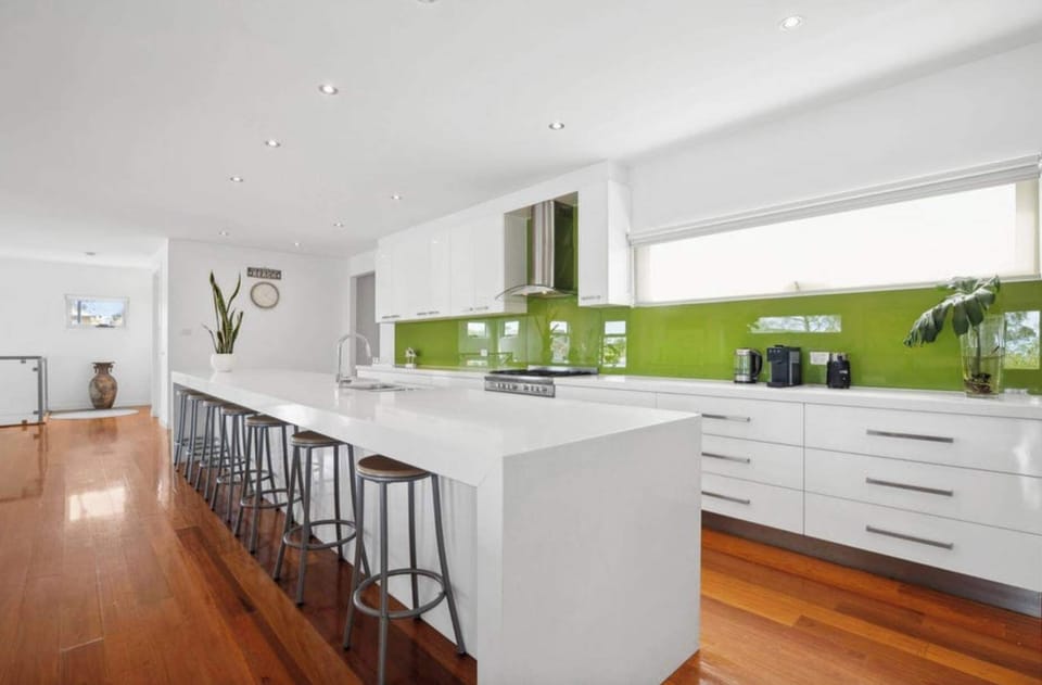 The contemporary kitchen, with its long island bench and breakfast bar seating, is perfectly set up for shared meals and entertaining. 