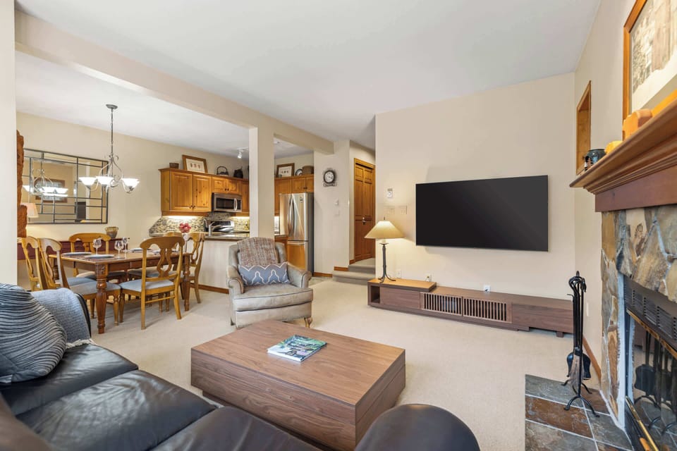 - Modern mountain-style living with fireplace and flat-screen TV  
- Open layout connecting dining, kitchen, and cozy lounge space  
- Whistler vacation rental designed for comfort and relaxation  