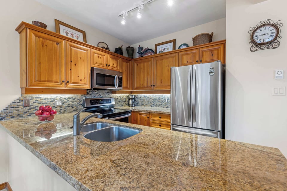 - Modern kitchen with granite countertops and stainless steel appliances  
- Fully equipped for cooking and dining in your mountain getaway  
- Whistler condo featuring luxury and rustic cabin style  