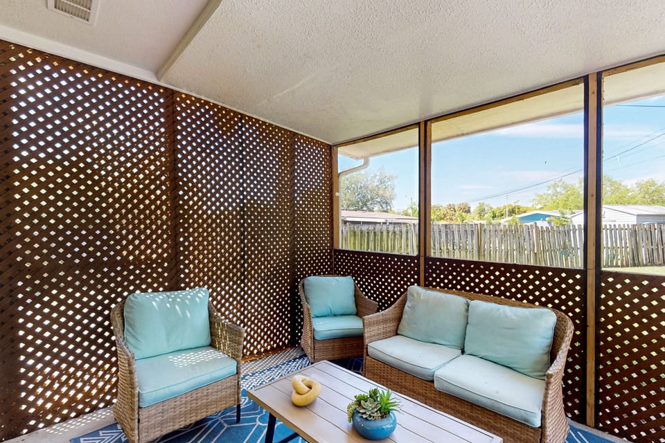 Screened-in outdoor patio with furniture