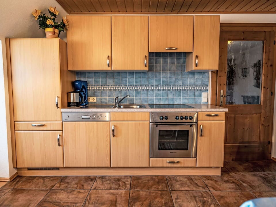 Kitchen, Countertop, Cabinetry, Furniture, Wood, Kitchen Appliance, Flooring, Sink, Major Appliance, Interior Design