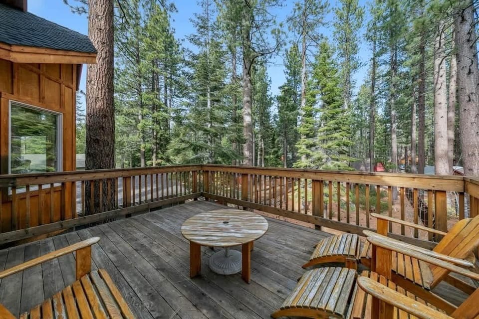 Private balcony surrounded by towering pines provides additional outdoor space to enjoy the home's peaceful forest setting.