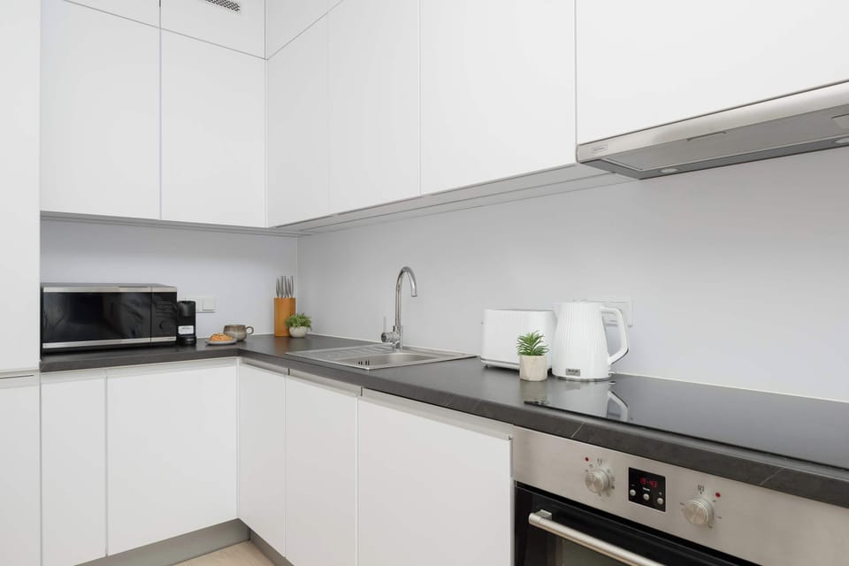 The sleek design of the kitchenette blending seamlessly with the living area.