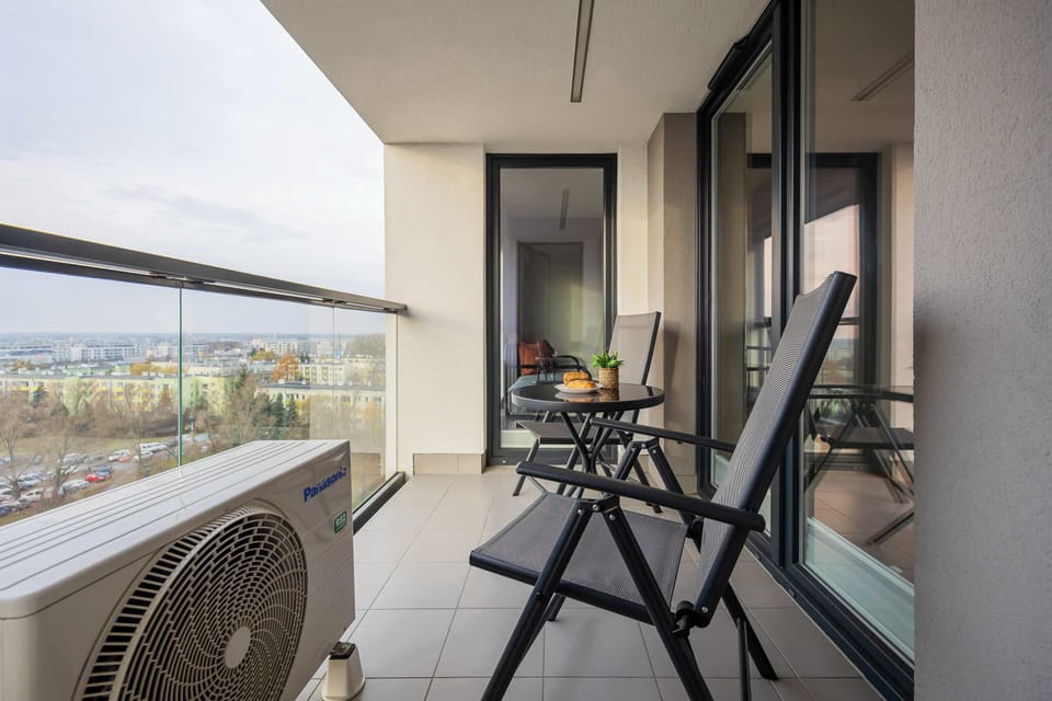 Private balcony set with a table and chairs, perfect for relaxing outdoors.