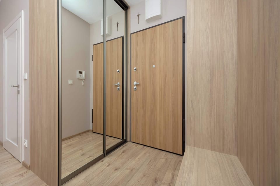 Additional hallway view with tall wardrobes ensuring practical storage space.