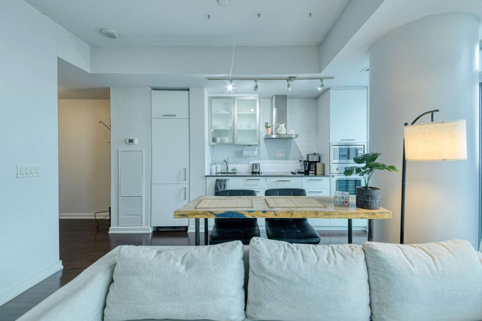 A sleek, modern kitchen featuring a unique live-edge breakfast bar, perfect for morning coffee or a quick meal.