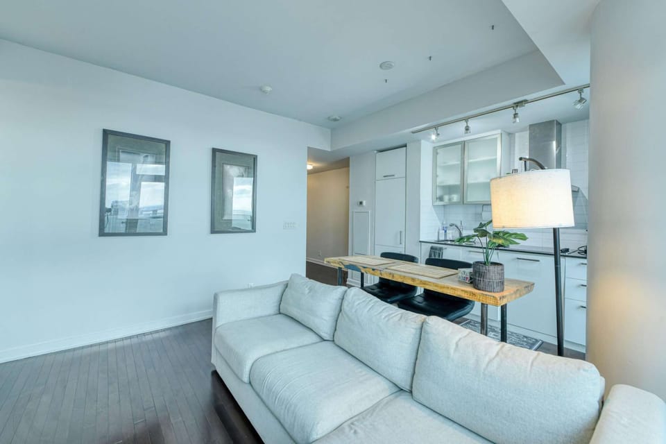 Bright studio with a cozy sofa and a live-edge breakfast bar.