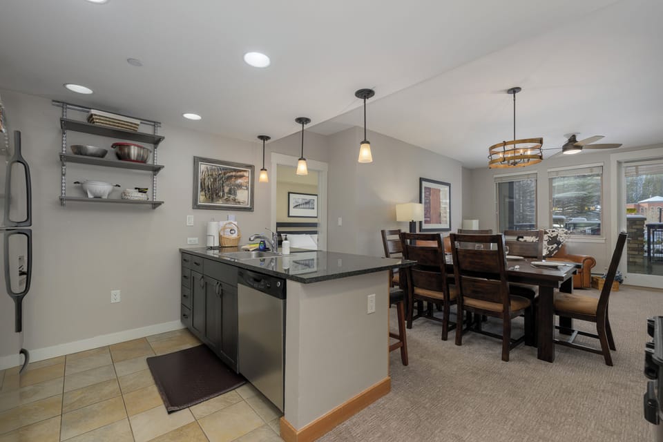 Your modern kitchen flows seamlessly into the dining area, where pendant lights cast a warm glow over meals shared with loved ones.