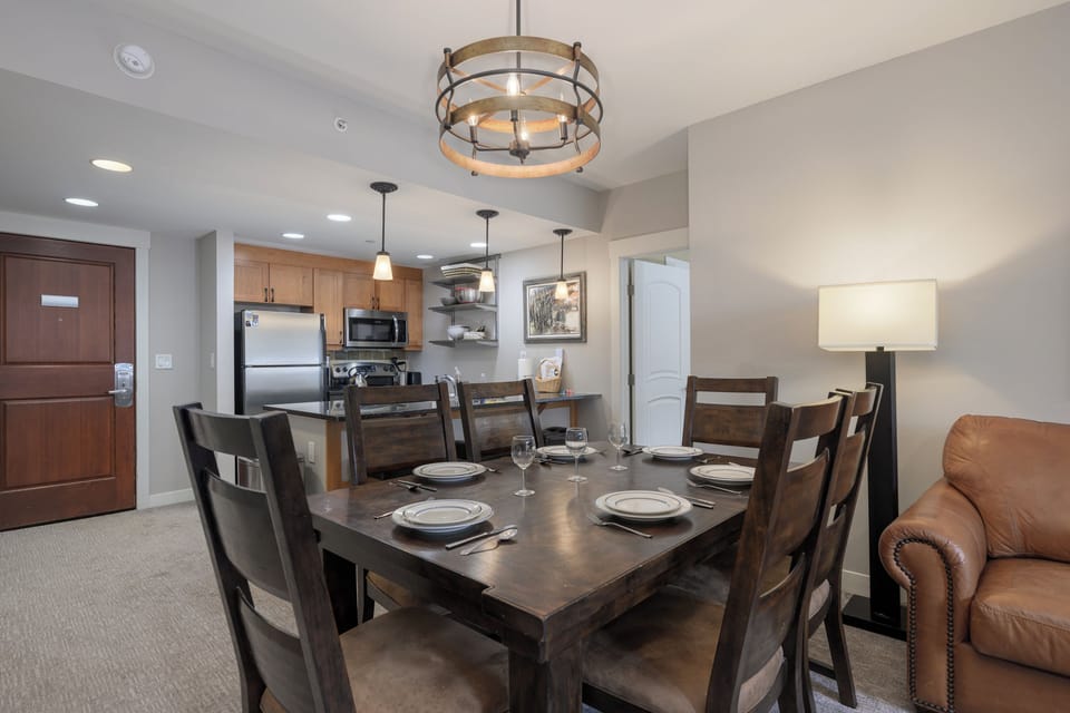Your spacious dining area features a handcrafted wooden table for eight, perfect for memorable meals with family and friends.