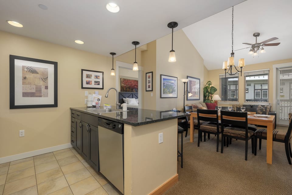 Your open kitchen flows seamlessly into the dining area, perfect for preparing meals and gathering with loved ones in this warm, light-filled space.