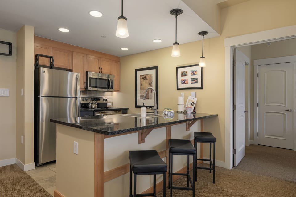 Your modern kitchen features granite counters, stainless appliances, and a breakfast bar where you can sip morning coffee.