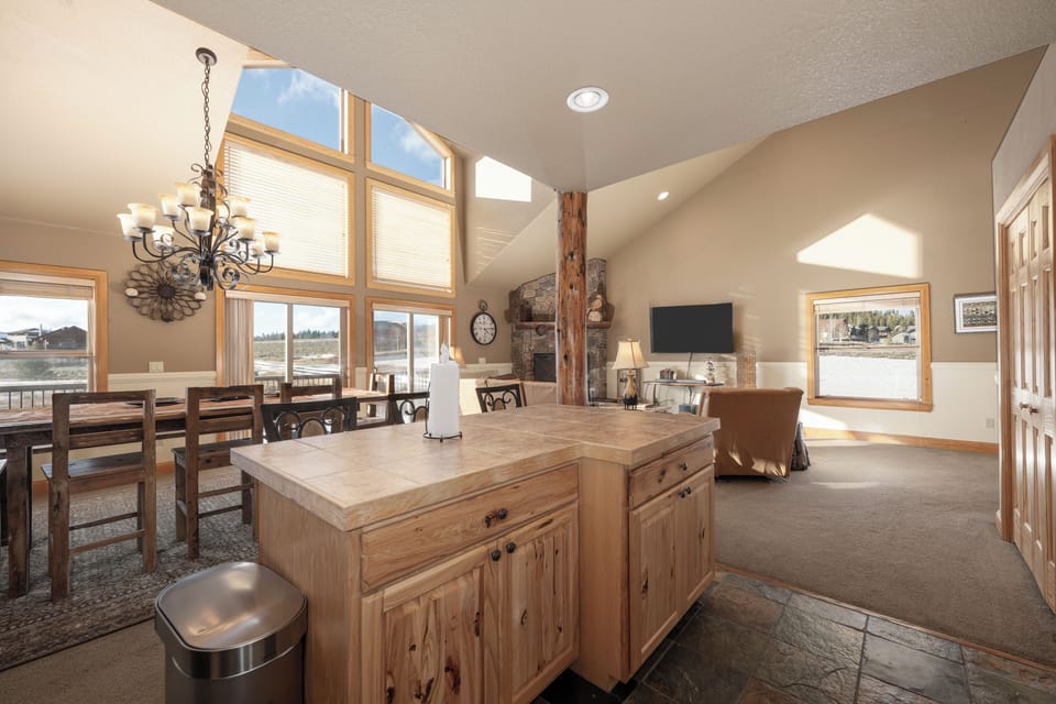 Relax in your spacious open-concept living area where rustic charm meets modern comfort, featuring soaring ceilings and abundant natural light.