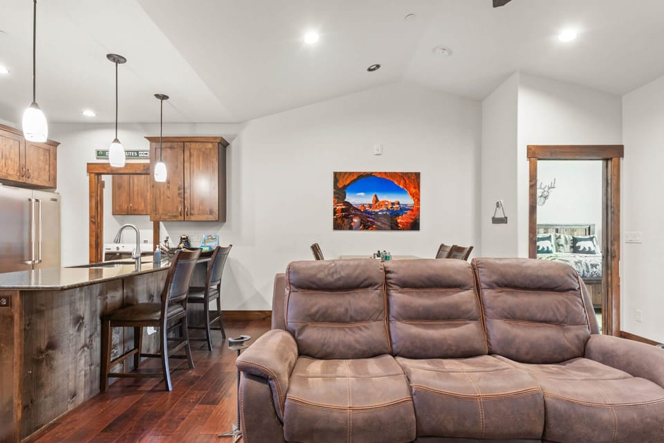Unwind in your spacious open living area where rustic wood meets modern comfort, perfect for relaxing after mountain adventures.