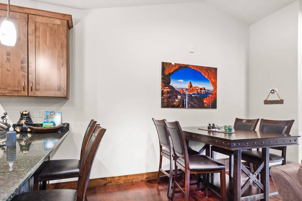 You'll love gathering around this stylish dining table for meals, with granite counters and warm wood accents creating the perfect mountain retreat atmosphere.