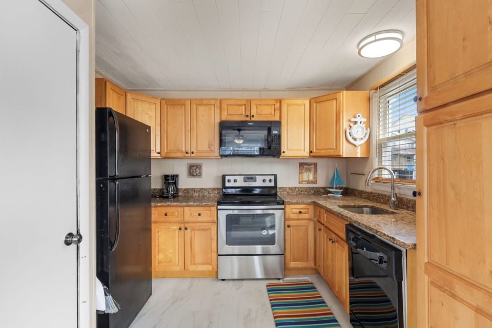 Just off the Living Area is the well-stocked Kitchen.