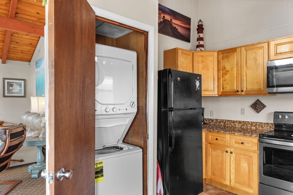 You'll be thrilled to find a Laundry Closet with Washer and Dryer in the Kitchen.