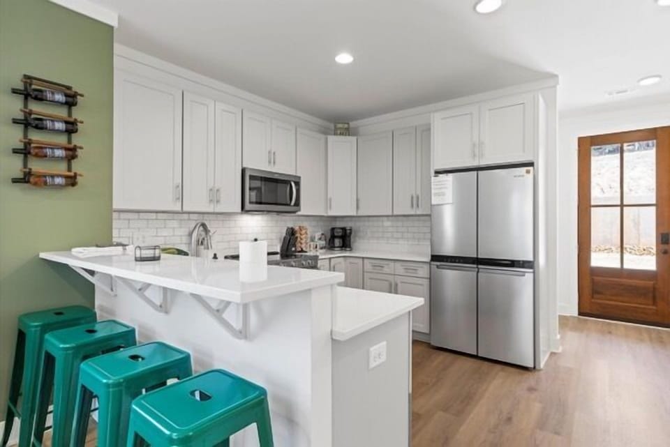 The kitchen bar offers additional seating for meals.
