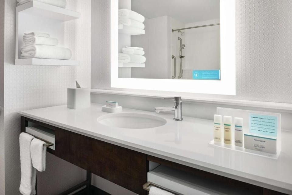 Refresh with a spotless vanity, bright mirror, and fluffy towels.