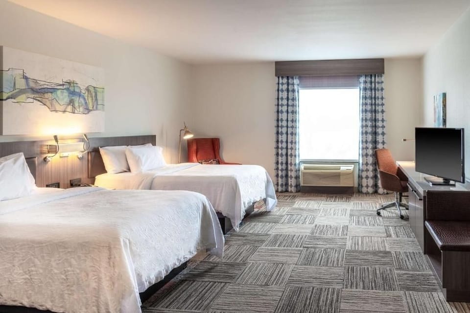 Step into a spacious room with two cloud-soft beds.