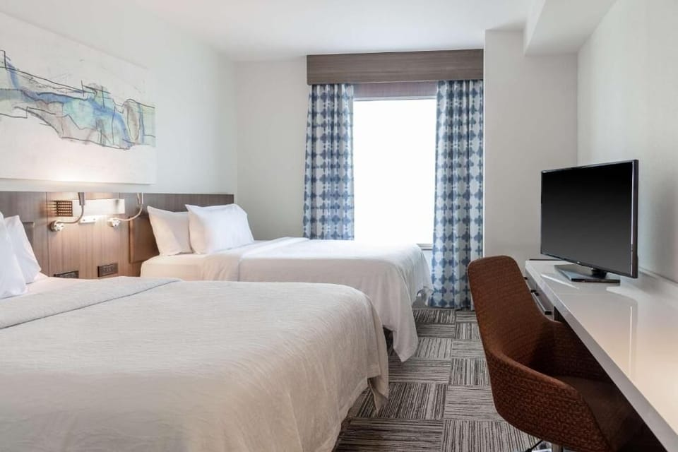 Wake up refreshed in crisp linens beside a sunlit window.