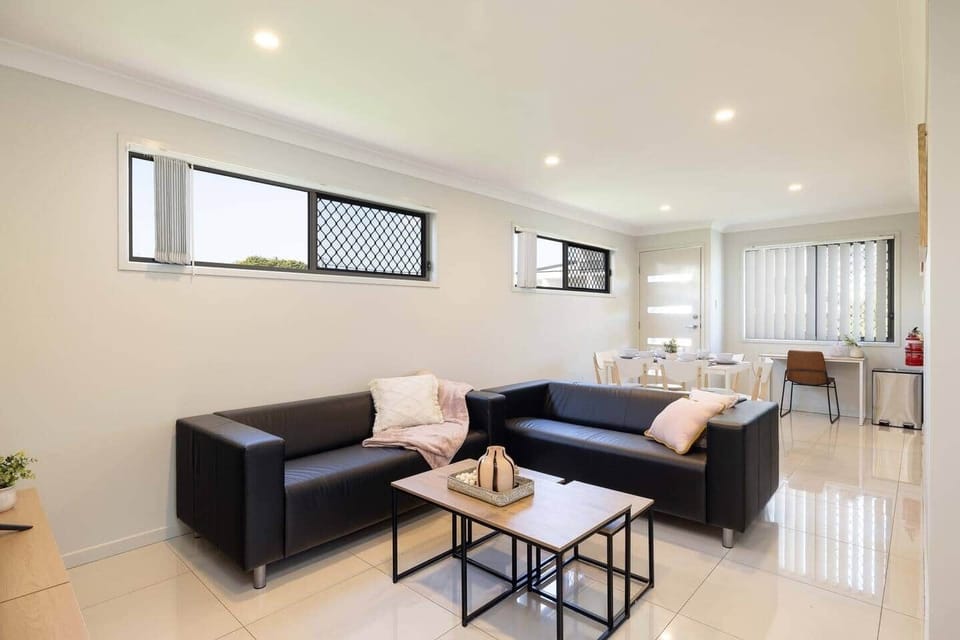 Living Area: Bright living space with comfortable seating and TV 