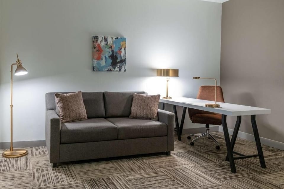 Spread out comfortably with lounge seating and a spacious work desk.