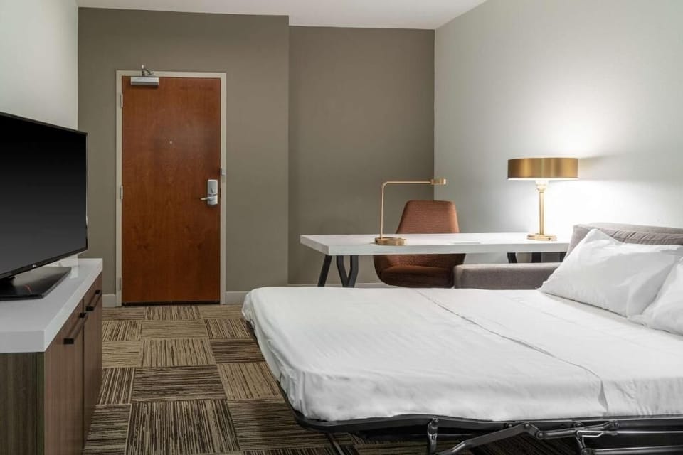 Unwind after exploring with a cozy bed and work desk.