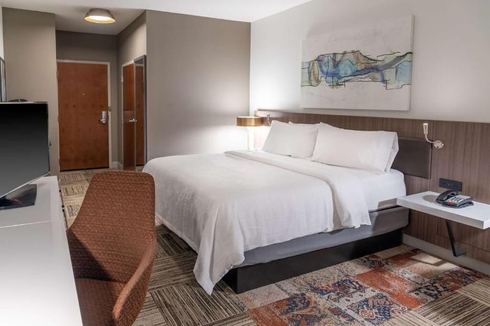 Settle into crisp linens and a calm, modern sleeping space.