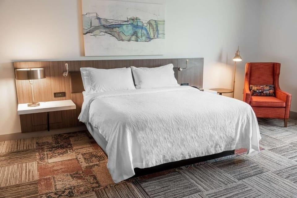 Relax into a plush king bed with soft, hotel-style bedding.