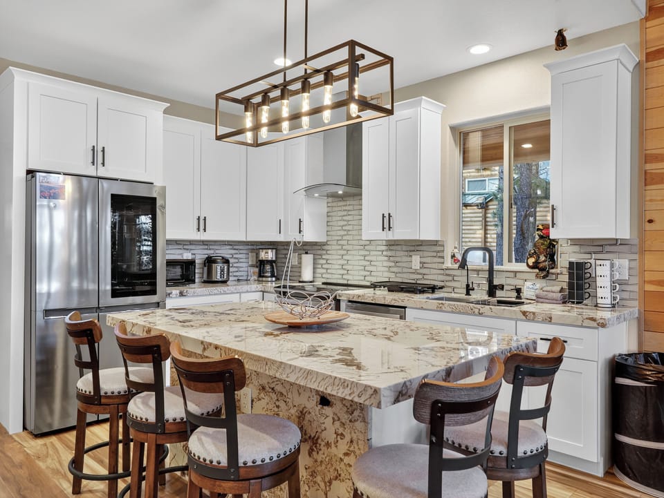 Step into your gourmet kitchen where culinary dreams come alive! The stunning granite island invites you to gather with loved ones while natural light streams through picture windows.