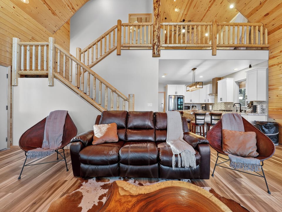 Sink into rich leather seating by the cozy fire, then head upstairs to your private loft sanctuary overlooking the open-concept space.