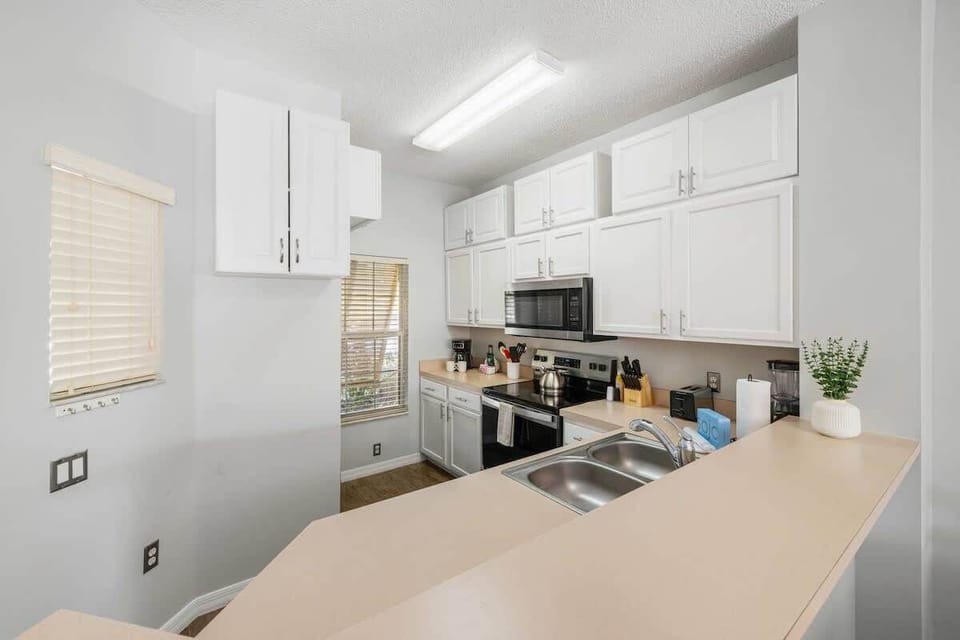 Fully equipped kitchen with stainless steel appliances.