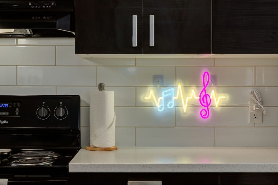 Sleek modern kitchen with dark cabinetry and white quartz countertops