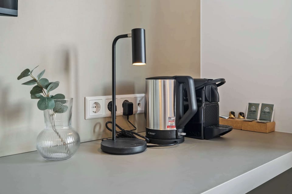  Desk space with a coffee maker and kettle for added convenience.