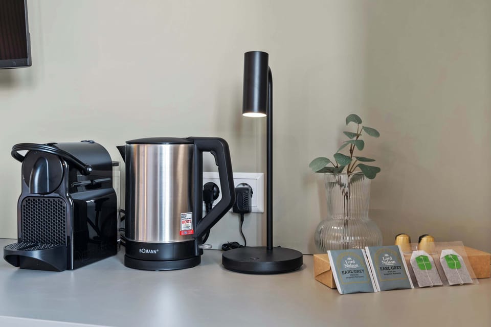  Desk space with a coffee maker and kettle for added convenience.