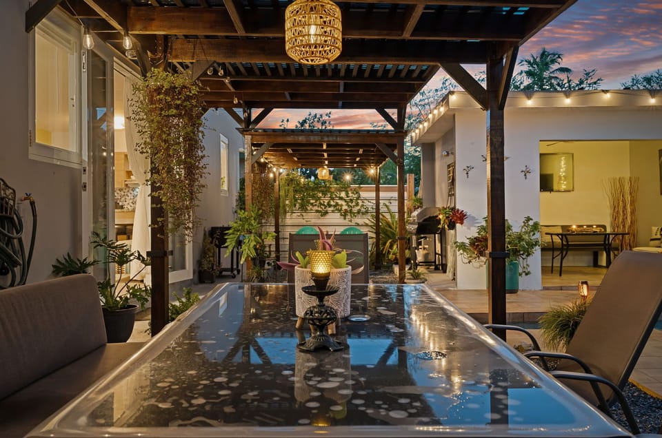 Covered outdoor dining area surrounded by tropical greenery