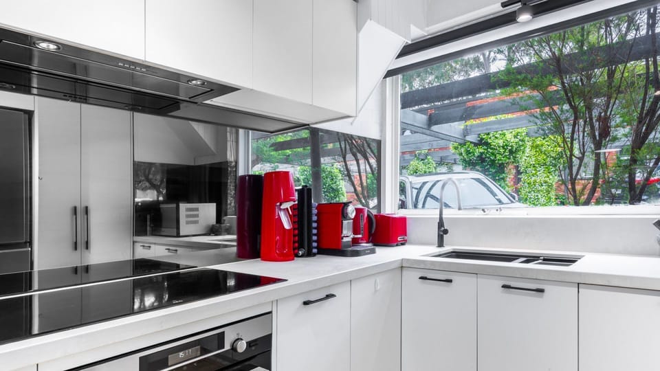 Fully equipped kitchen with quality appliances and garden views.