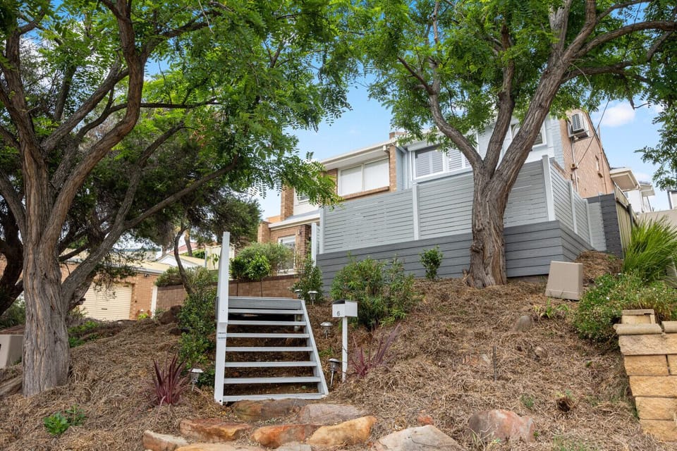 The first bedroom offers calm comfort with a queen bed, AC, ceiling fan and generous storage.