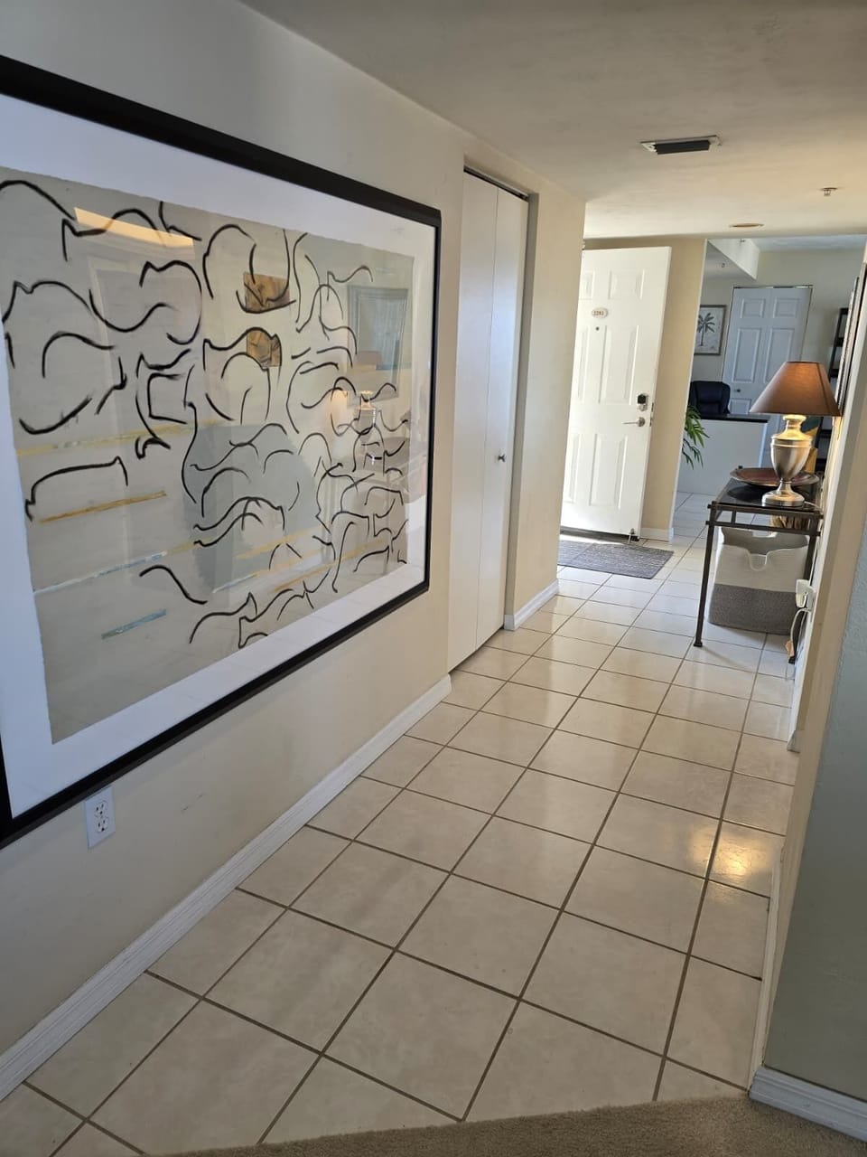 Unit entrance and main hallway with office in the background.