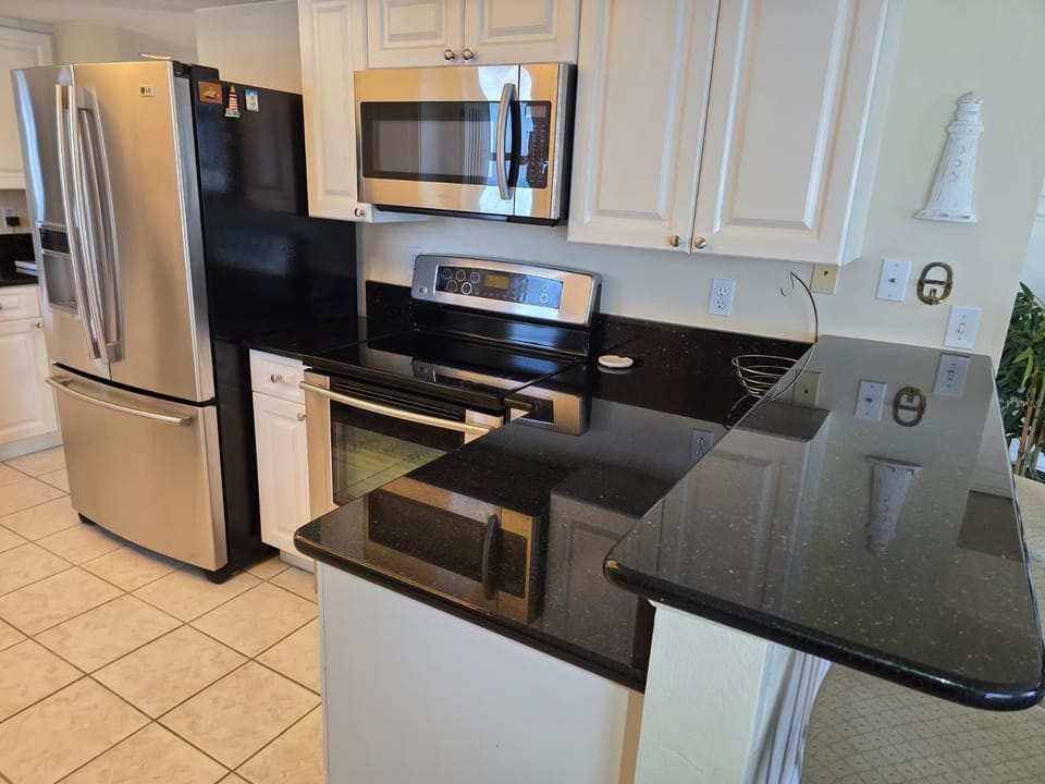 Full kitchen with plates and utensils.