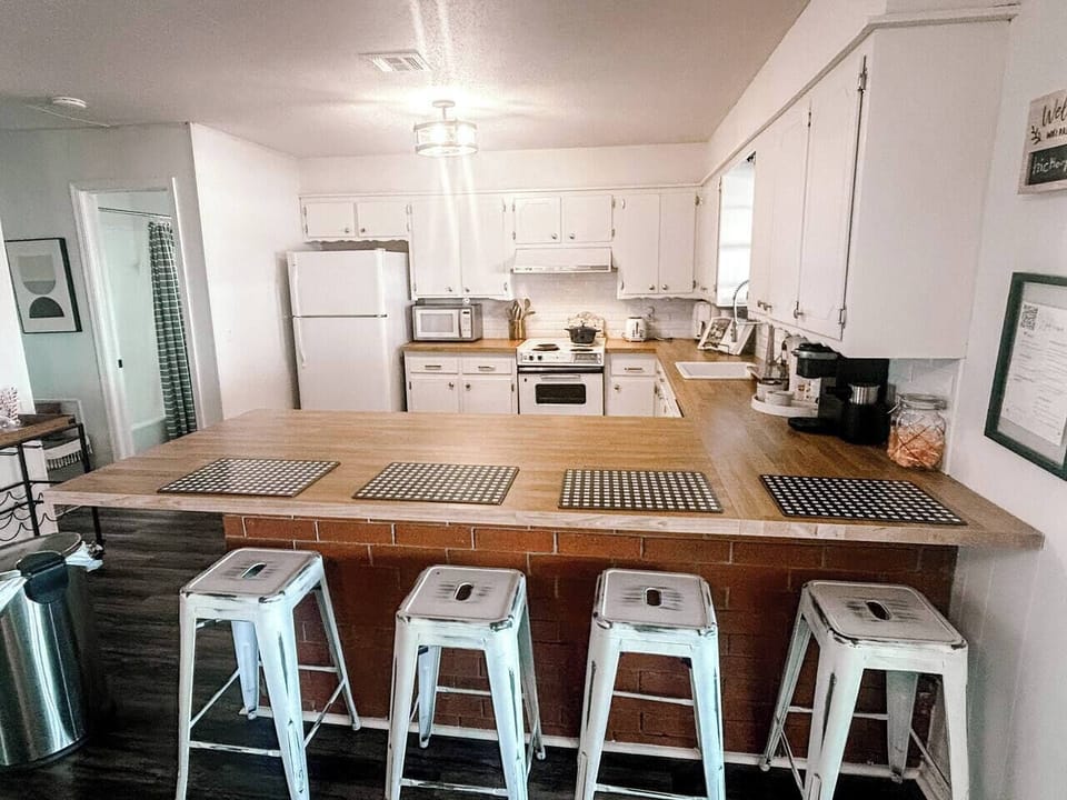 Fully stocked kitchen with all essentials, keurig coffee station, and basic cooking spices and oil