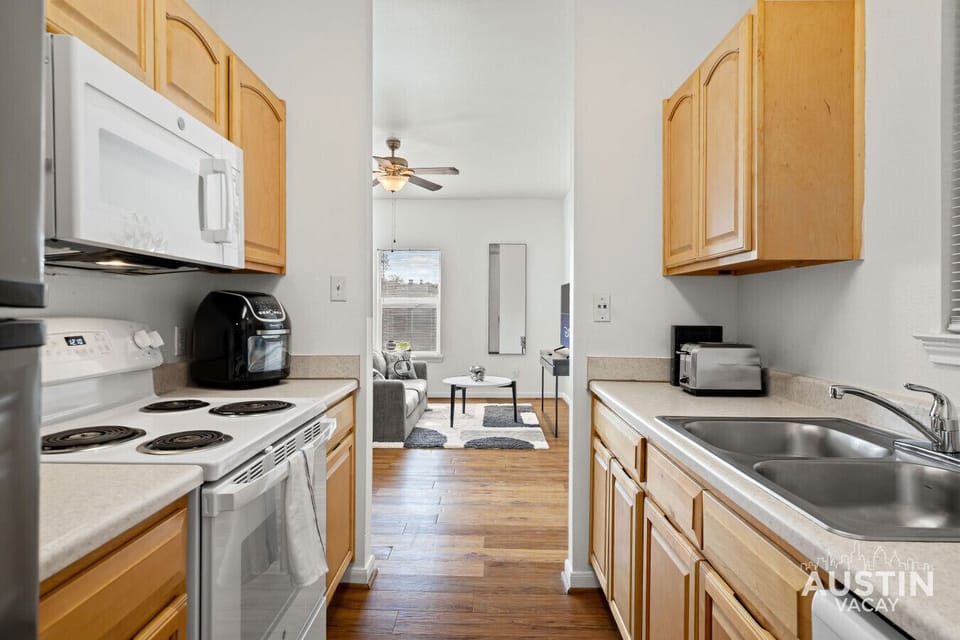 Microwave, stove, air fryer, fridge, all within reach and ready to feed you fast