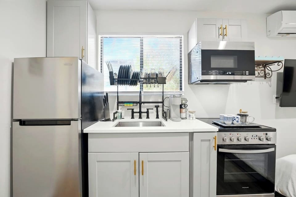 Kitchen with refrigerator, coffee station, Oven and more