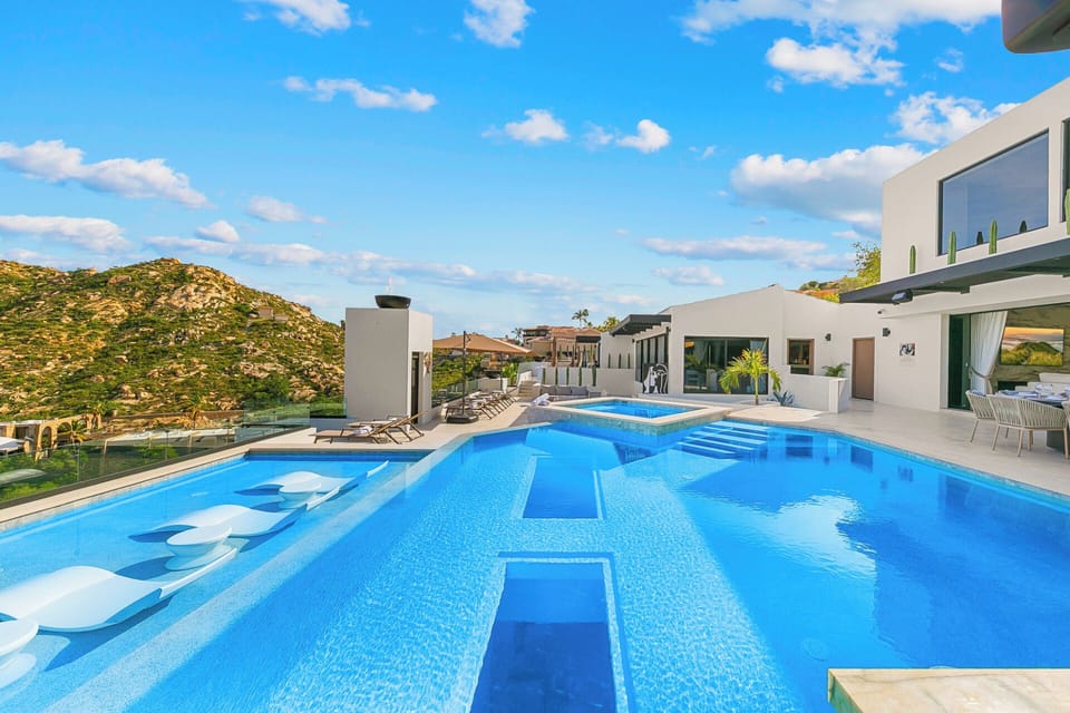 Tanning ledge, glass-bottom pool, luxe loungers, and views of marina,vistas+sea.