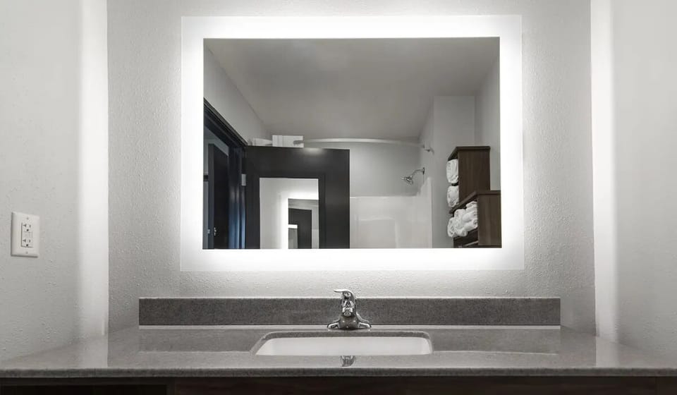 Get ready effortlessly with a bright mirror and roomy vanity.