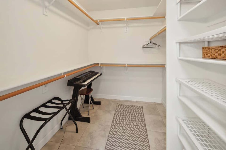 Keep clothes and bags neatly tucked away in the master bedroom closet. 