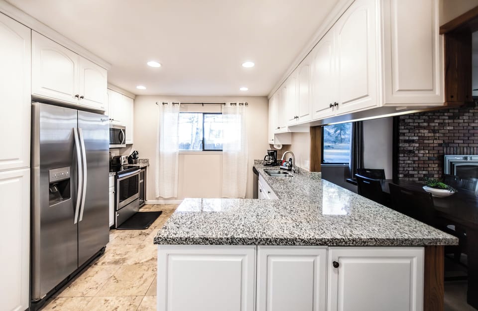 Kitchen has many appliances including a new wine cooler 