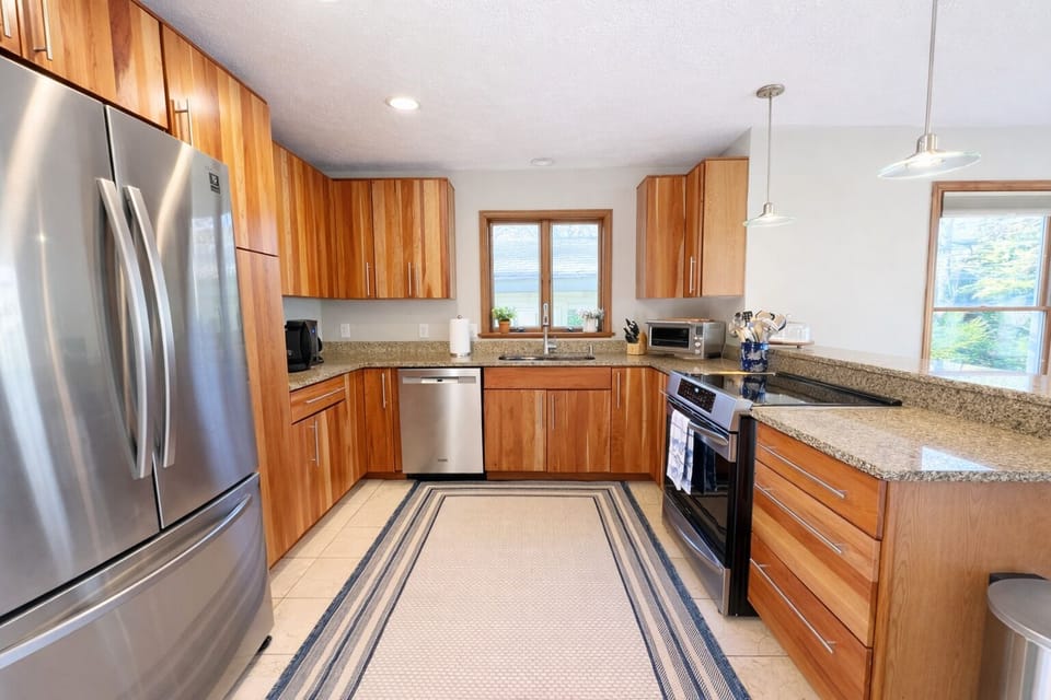 Large kitchen with brand new appliances and eat in bar.