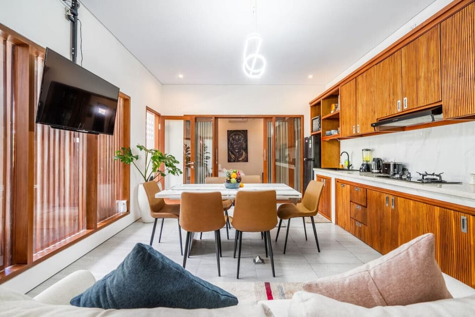 Dining and living area with built-in cabinetry